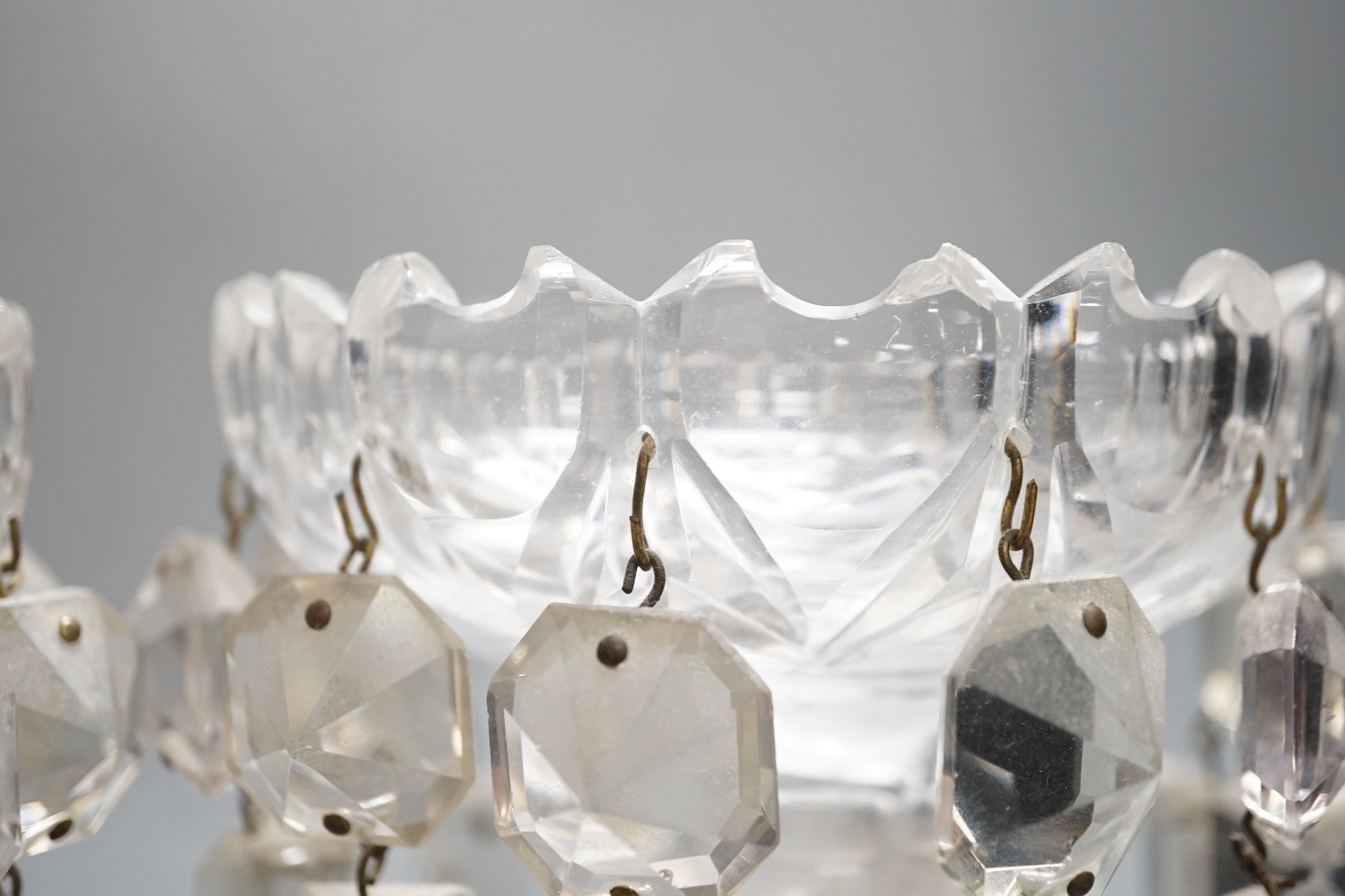 A pair of Victorian cut glass candle holders with 'spear' lustre drops (faults), 23cm high